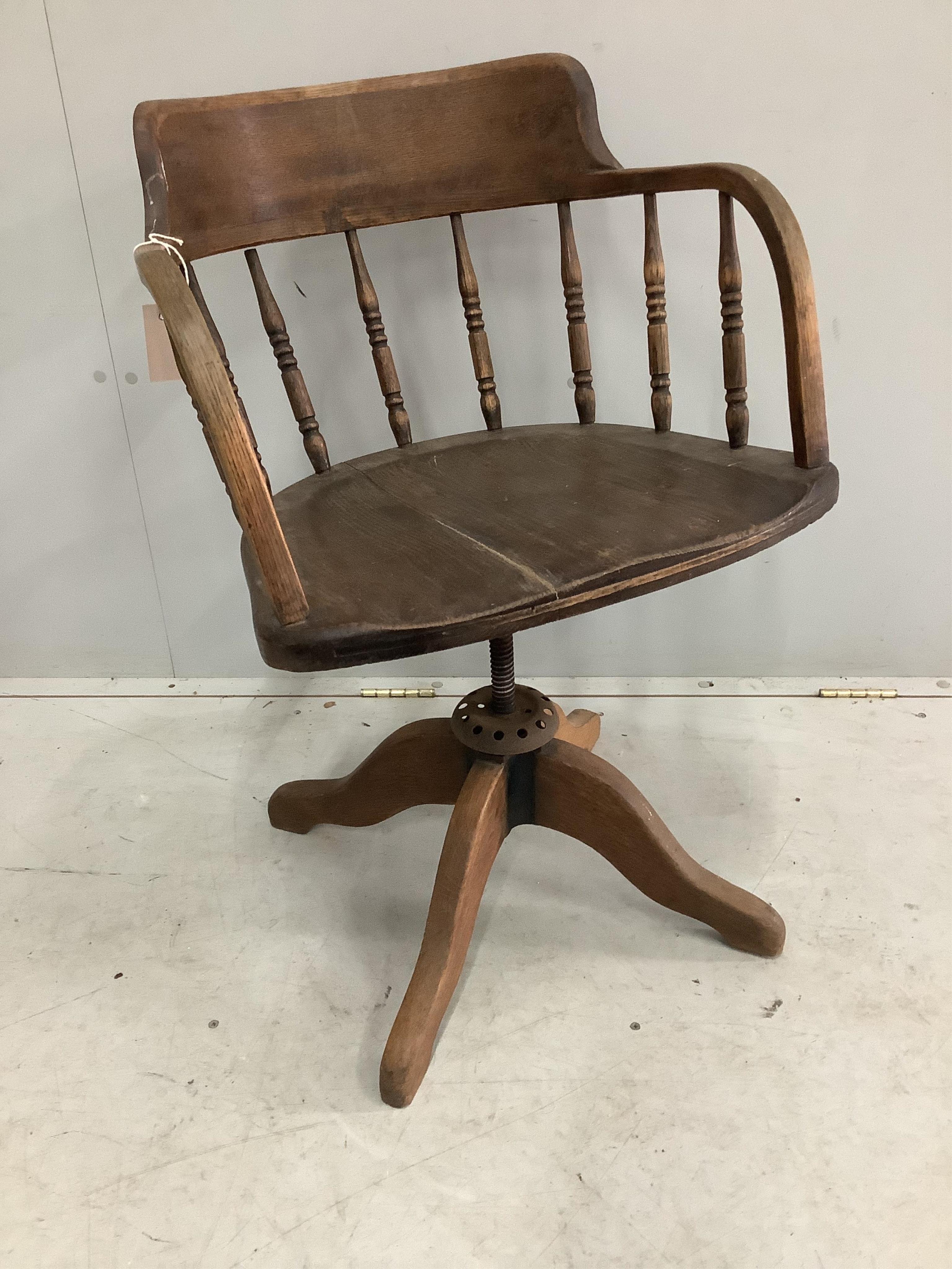 An early 20th century oak swivel desk chair, width 54cm, depth 46cm, height 85cm. Condition - poor